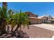 Two-story house with three-car garage and mature palm trees at 1231 N Layman St, Gilbert, AZ 85233