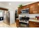 Modern kitchen with stainless steel appliances and wood cabinets at 1231 N Layman St, Gilbert, AZ 85233