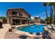 Stunning kidney-shaped pool, surrounded by rocks and a patio at 1231 N Layman St, Gilbert, AZ 85233