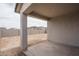 Covered patio leads to an empty lot, waiting for your personal touch at 12722 W Luxton Ln, Avondale, AZ 85323