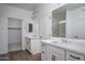 Bathroom with double sinks and walk in closet with a shower behind a glass door at 12722 W Luxton Ln, Avondale, AZ 85323
