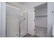 Bathroom shower with a glass door leading into a closet with carpet at 12722 W Luxton Ln, Avondale, AZ 85323