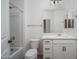 Bright bathroom with white cabinets, tub-shower combo and modern fixtures at 12722 W Luxton Ln, Avondale, AZ 85323