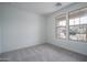 Empty bedroom with neutral carpet and natural light from the window at 12722 W Luxton Ln, Avondale, AZ 85323
