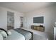 This bedroom features a TV, decor, and access to the en-suite bathroom at 12722 W Luxton Ln, Avondale, AZ 85323