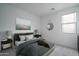 Comfortable bedroom with neutral tones, a plush bed, and soft lighting at 12722 W Luxton Ln, Avondale, AZ 85323