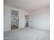 Bright, carpeted bedroom with a view into the en-suite bathroom and walk-in closet at 12722 W Luxton Ln, Avondale, AZ 85323