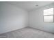 An empty bedroom with carpet and two windows providing plenty of natural light at 12722 W Luxton Ln, Avondale, AZ 85323