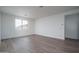 Bright and airy bedroom with hardwood floors and a large window offering natural light at 12722 W Luxton Ln, Avondale, AZ 85323