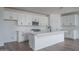 Modern kitchen with white cabinets, stainless steel appliances, and a large central island at 12722 W Luxton Ln, Avondale, AZ 85323