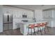 Contemporary kitchen featuring stainless steel appliances, a large island, and bar stool seating at 12722 W Luxton Ln, Avondale, AZ 85323