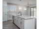 Bright kitchen featuring an island with a sink, stainless steel appliances, and white cabinetry at 12722 W Luxton Ln, Avondale, AZ 85323