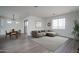 Cozy living room with a modern sectional sofa, area rug, and a dining area with wooden table at 12722 W Luxton Ln, Avondale, AZ 85323