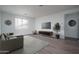 Comfortable living room featuring a sofa, TV, and natural light from the window at 12722 W Luxton Ln, Avondale, AZ 85323