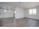 Spacious living room with hardwood floors, recessed lighting, and sliding glass doors to the patio at 12722 W Luxton Ln, Avondale, AZ 85323