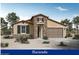 One-story home with stone accents and a two-car garage at 12725 W Luxton Ln, Avondale, AZ 85323