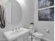 Stylish powder room with pedestal sink and oval mirror at 13331 E Parkview Ln, Scottsdale, AZ 85255