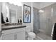 Modern bathroom with a glass shower, gray tile, and updated vanity at 13331 E Parkview Ln, Scottsdale, AZ 85255