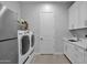 Bright laundry room with white cabinets and modern appliances at 13331 E Parkview Ln, Scottsdale, AZ 85255