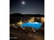 Tranquil nighttime view of a rectangular pool and surrounding patio at 13331 E Parkview Ln, Scottsdale, AZ 85255