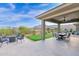 Covered patio with dining area, fire pit, and putting green at 13331 E Parkview Ln, Scottsdale, AZ 85255