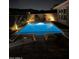 Blue illuminated pool at night with surrounding patio furniture at 13331 E Parkview Ln, Scottsdale, AZ 85255