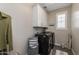 Laundry room with washer, dryer, and white cabinets at 1336 E Sierra Vista Dr, Phoenix, AZ 85014