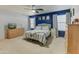 Main bedroom with blue accent wall and wood dresser at 15742 W Watson W Ln, Surprise, AZ 85379