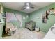 Charming Bedroom with crib, rocker, and soothing decor at 15742 W Watson W Ln, Surprise, AZ 85379