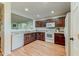 Kitchen with dark wood cabinets and white appliances at 15742 W Watson W Ln, Surprise, AZ 85379