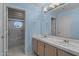 Bathroom with dual sinks, light blue walls and tiled floor at 16206 S 11Th Pl, Phoenix, AZ 85048