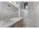 Bathroom boasts dual sinks, a large soaking tub, and a glass block window for natural light at 16206 S 11Th Pl, Phoenix, AZ 85048