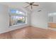 Bright bedroom featuring a large window and ceiling fan at 16206 S 11Th Pl, Phoenix, AZ 85048