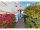 Beautiful entryway with a teal gate and vibrant flowers at 16206 S 11Th Pl, Phoenix, AZ 85048