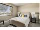 Bright bedroom with a queen-size bed and window views at 16310 W Boulder Dr, Surprise, AZ 85374