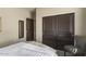 Comfortable bedroom with sliding closet doors and a chair at 16310 W Boulder Dr, Surprise, AZ 85374