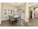 Elegant dining room features a round table, chandelier, and hardwood floors at 16310 W Boulder Dr, Surprise, AZ 85374