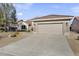 House exterior with a two-car garage and stone accents at 16310 W Boulder Dr, Surprise, AZ 85374