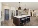 Bright kitchen boasts an island, stainless steel appliances, and dark wood cabinets at 16310 W Boulder Dr, Surprise, AZ 85374