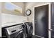 Convenient laundry room with stacked washer and dryer at 16310 W Boulder Dr, Surprise, AZ 85374