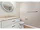 Clean bathroom with white vanity and a round mirror at 1682 W Campbell Ave, Phoenix, AZ 85015