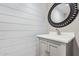 Stylish bathroom with white vanity, shiplap walls, and round mirror at 1682 W Campbell Ave, Phoenix, AZ 85015