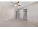 Spacious bedroom with neutral walls, carpet, ceiling fan and double door closet at 1682 W Campbell Ave, Phoenix, AZ 85015