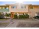 Cute condo with a well-manicured front yard and inviting wooden door at 1682 W Campbell Ave, Phoenix, AZ 85015