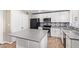 Updated kitchen featuring white shaker cabinets and gray quartz countertops at 1682 W Campbell Ave, Phoenix, AZ 85015