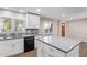 Modern kitchen with island, white cabinets, and gray countertops at 1682 W Campbell Ave, Phoenix, AZ 85015