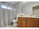 Bathroom with wood vanity and shower/tub combo at 17009 S 30Th Way, Phoenix, AZ 85048