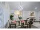 Bright dining room featuring a large table, chandelier, and adjacent fireplace at 17009 S 30Th Way, Phoenix, AZ 85048