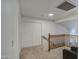 Upstairs hallway with wood railing, carpet, and access to bedrooms at 17009 S 30Th Way, Phoenix, AZ 85048