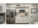 Kitchen boasts stainless steel appliances, white cabinets, and quartz countertops at 17009 S 30Th Way, Phoenix, AZ 85048